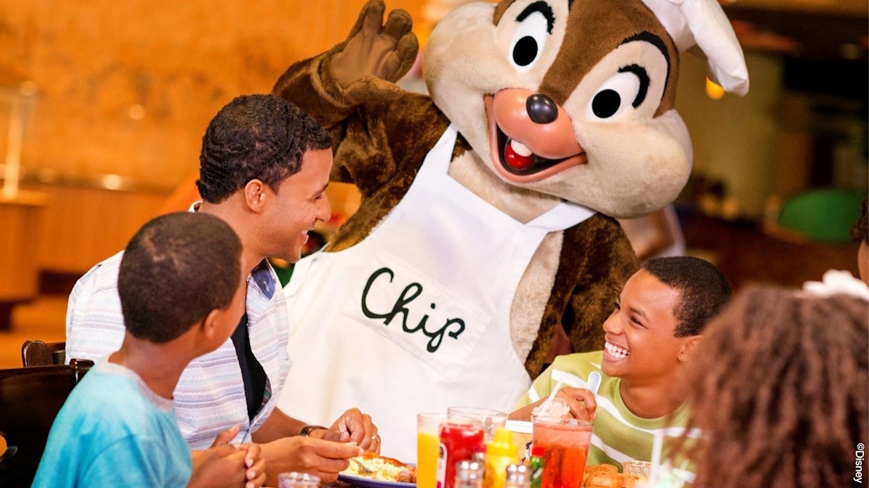 Guests enjoying a meal with a character at Disneyland Park, California restaurant.