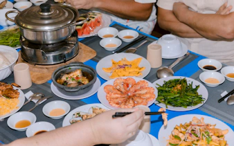 Seafood lunch spread on speed boat tour of 4 Islands, featuring prawns and local dishes.