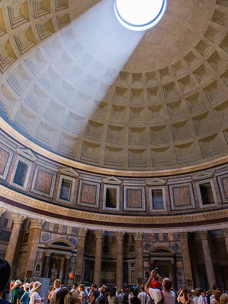 Dome of the Pantheon in Rome with sunlight streaming through the oculus.