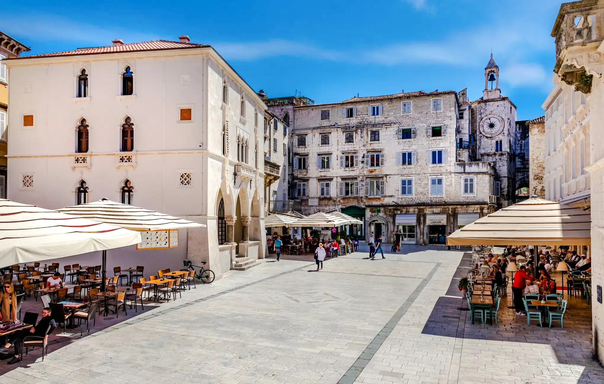 Old town square with cafes and historic buildings in Split, Croatia, near Diocletian's Palace.
