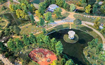 Aerial view of Vondelpark in Amsterdam with people relaxing on the grass and a pond with a gazebo.
