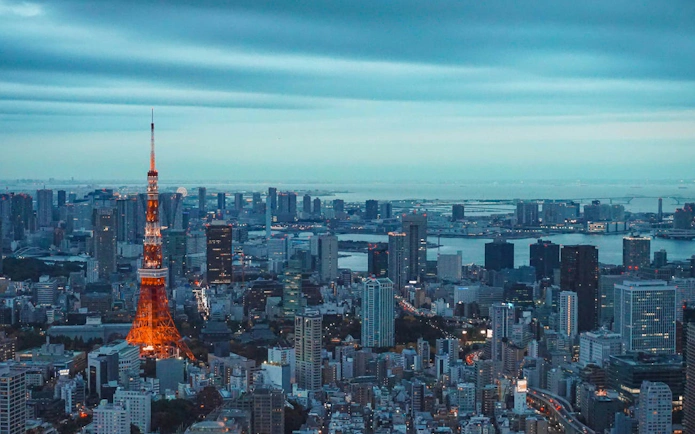 Tokyo skyline with illuminated Tokyo Tower at dusk, viewed from the Tokyo City View Observation Deck.