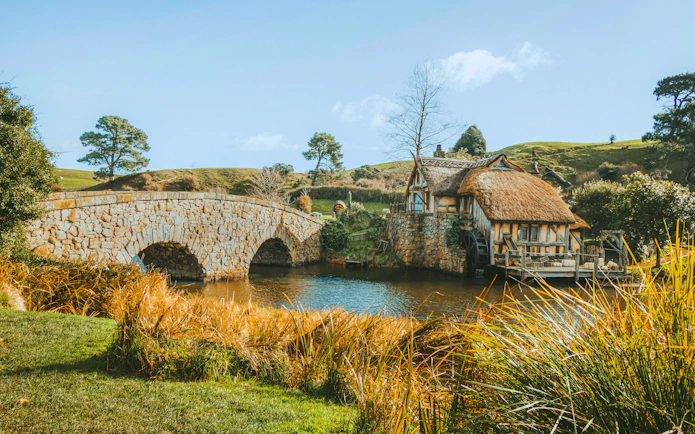 Double arched stone bridge and mill at Hobbiton Movie Set, Matamata, New Zealand.