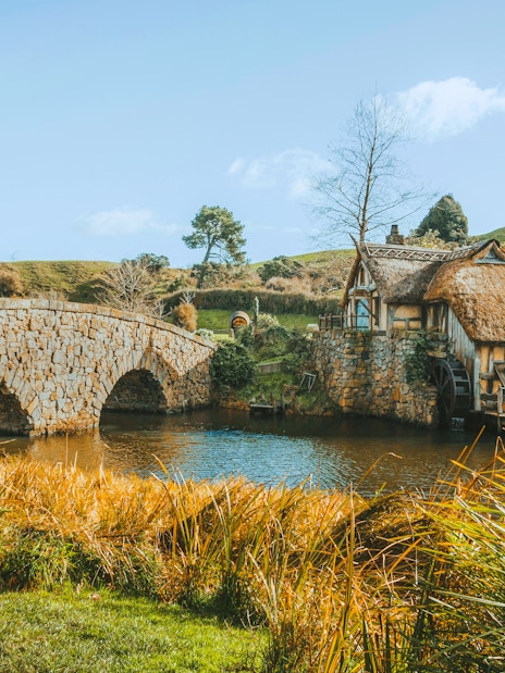 Double arched stone bridge and mill at Hobbiton Movie Set, Matamata, New Zealand.