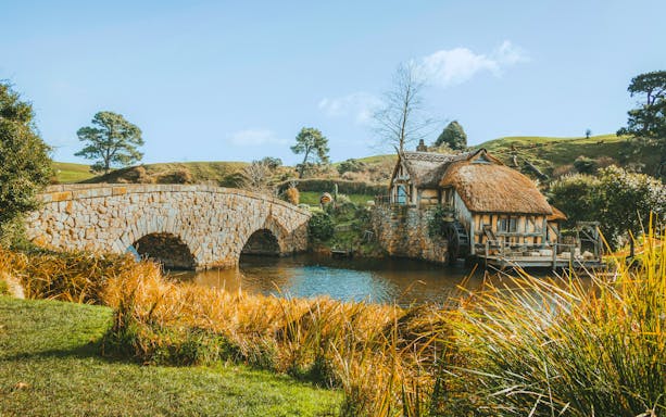Double arched stone bridge and mill at Hobbiton Movie Set, Matamata, New Zealand.