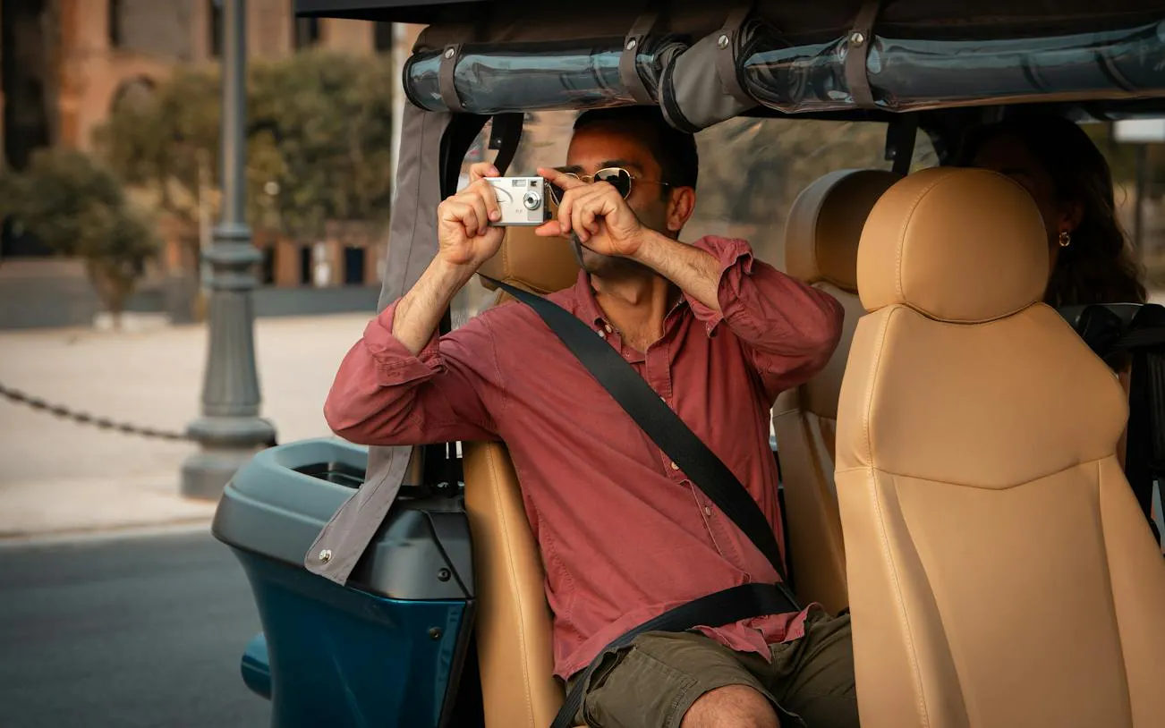 Tourist taking photos from a golf cart during a private panoramic tour in Rome.