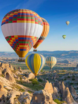 Hot air balloons over Cappadocia's unique rock formations, Turkey.