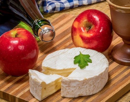 Visitors sampling apple cider at a Normandy D-Day tour in France.