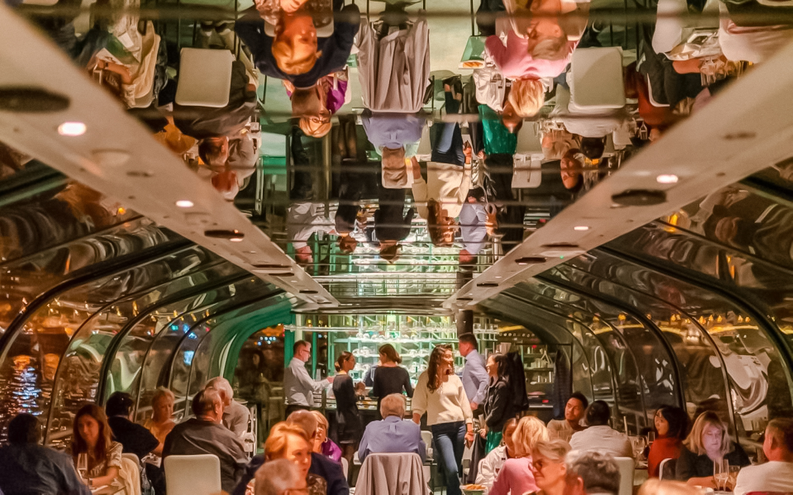 Guests dining inside Budapest Danube River candlelit dinner cruise.