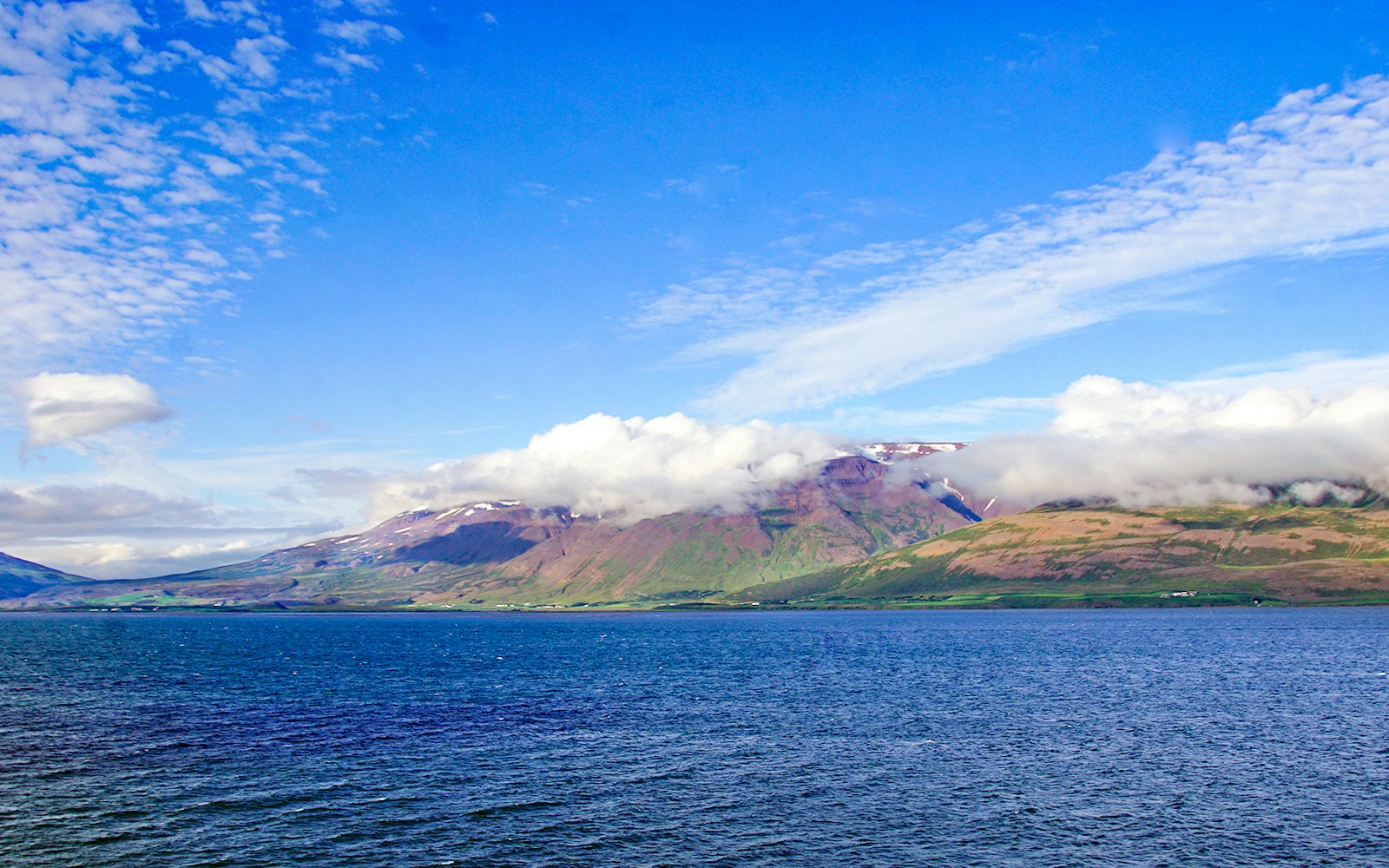 Eyjafjörður fjord with mountains and clouds in Akureyri, Iceland.
