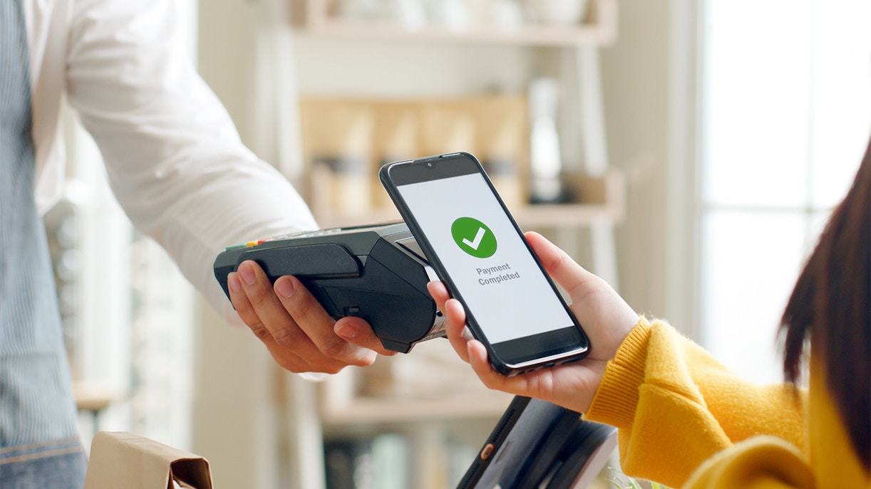 Customer using smartphone for payment at Anfield Stadium cashless contactless technology