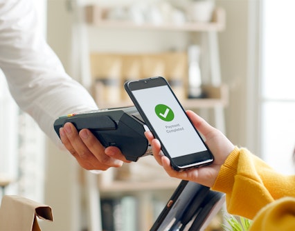Mobile payment completed on a smartphone at a point-of-sale terminal.