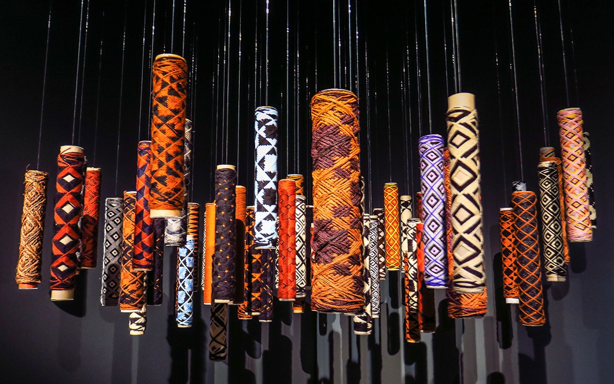 Colorful hanging art installations at MONA with intricate patterns.