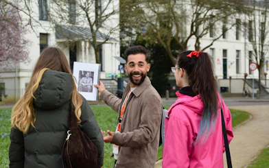 Guide showing WWII photo during Haarlem walking tour.