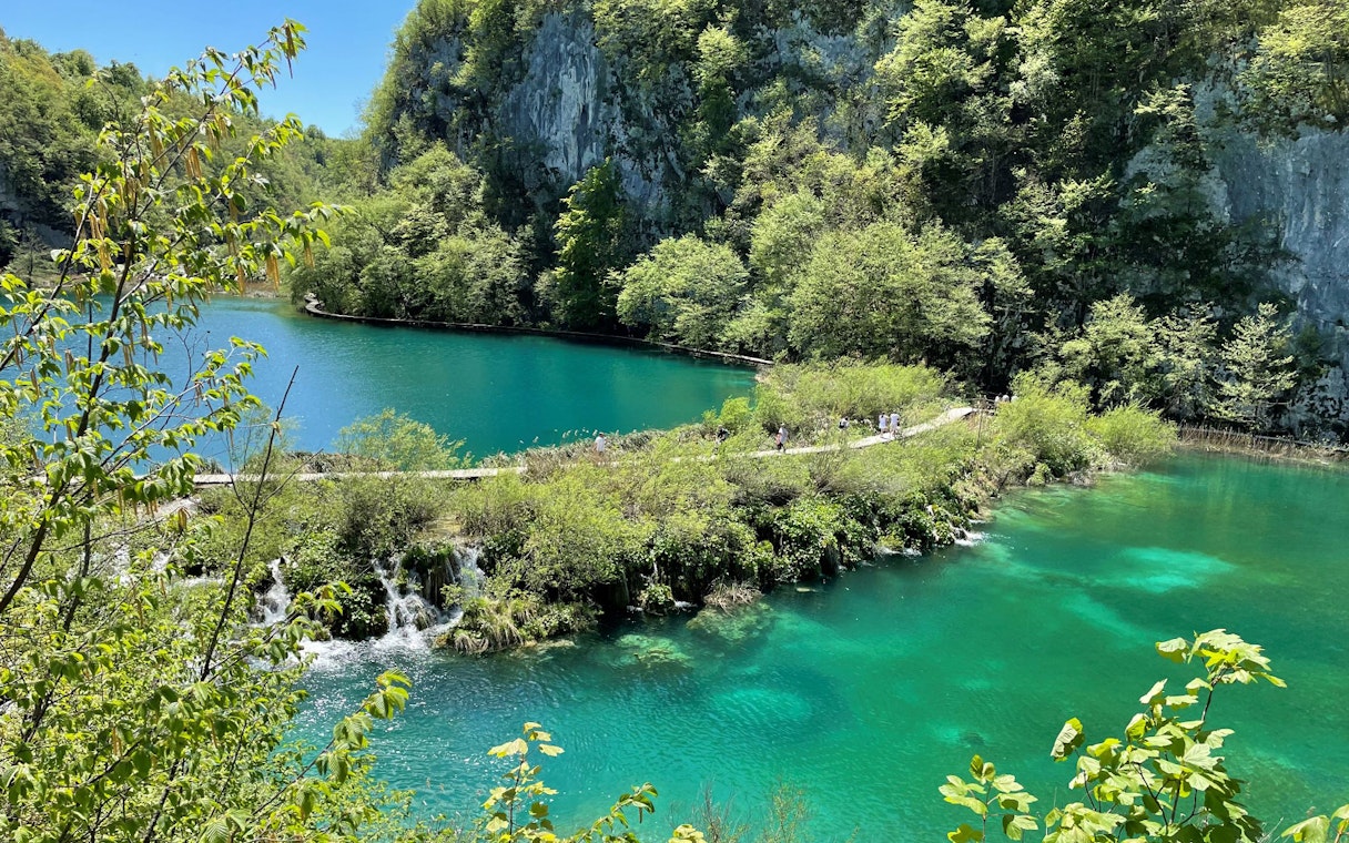 Plitvice Lakes National Park turquoise lake and lush greenery, Croatia.