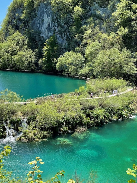 Plitvice Lakes National Park turquoise lake and lush greenery, Croatia.