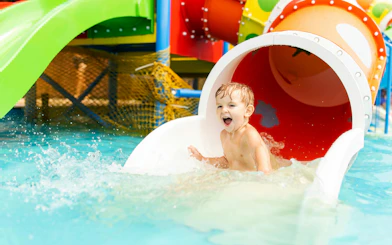 Little boy enjoying water slide at Agadir Aqua Park.