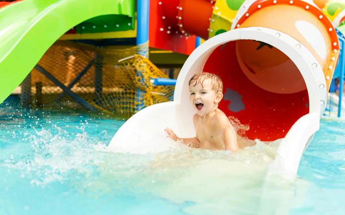 Little boy enjoying water slide at Agadir Aqua Park.