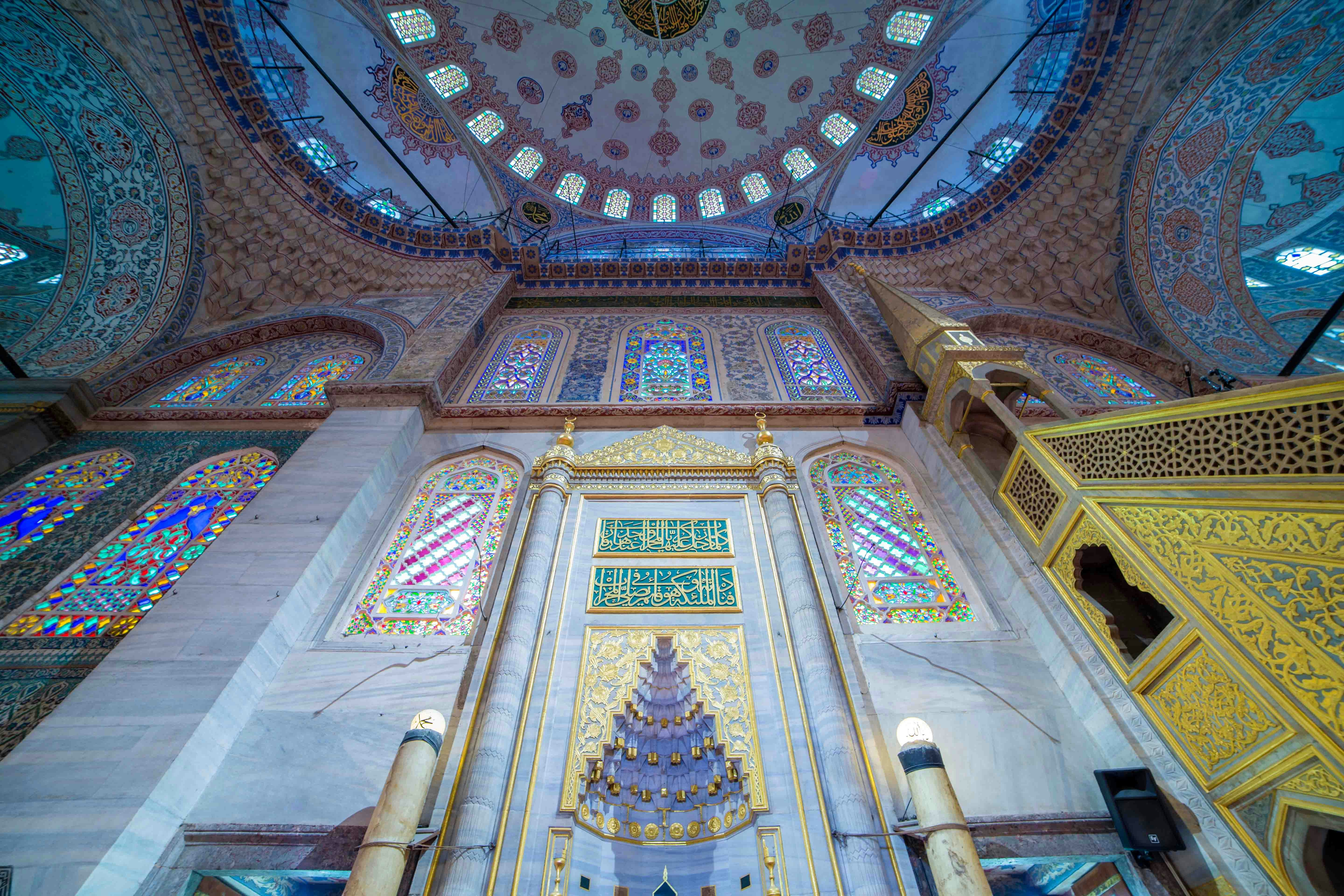 Blue Mosque mihrab with intricate tilework and Arabic calligraphy in Istanbul, Turkey.