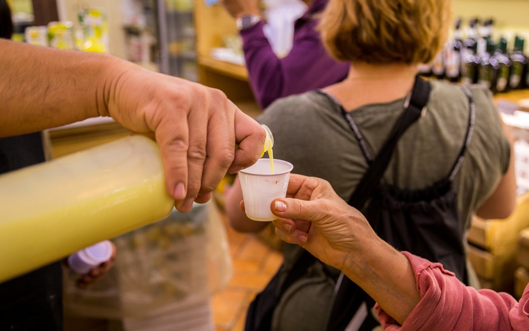 Pouring limoncello sample during Amalfi and Positano tour from Rome.