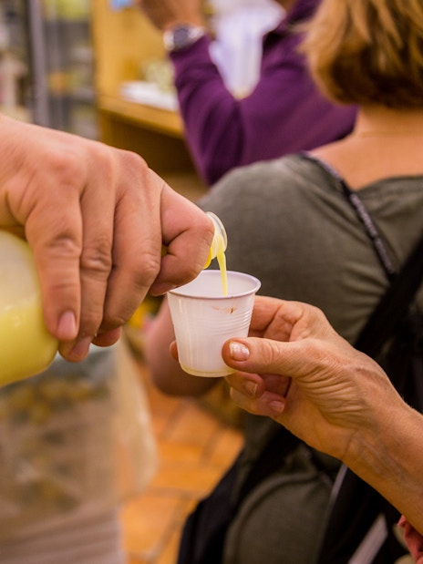 Pouring limoncello sample during Amalfi and Positano tour from Rome.