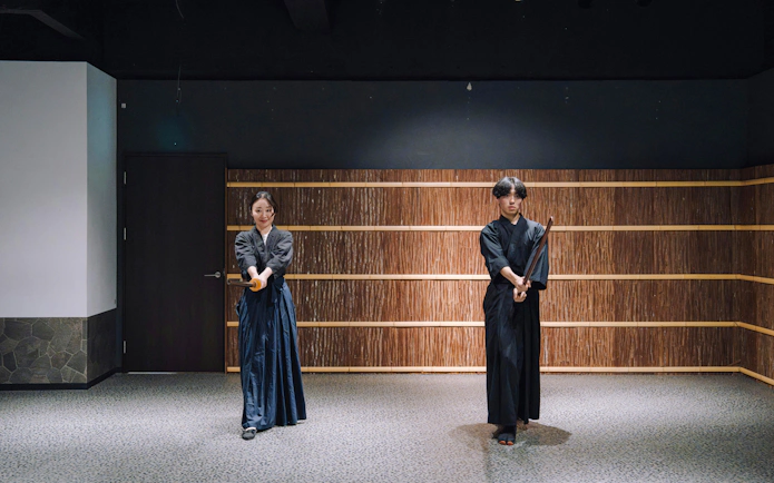 Couple practicing sword techniques at Samurai Museum Tokyo in Shinjuku.