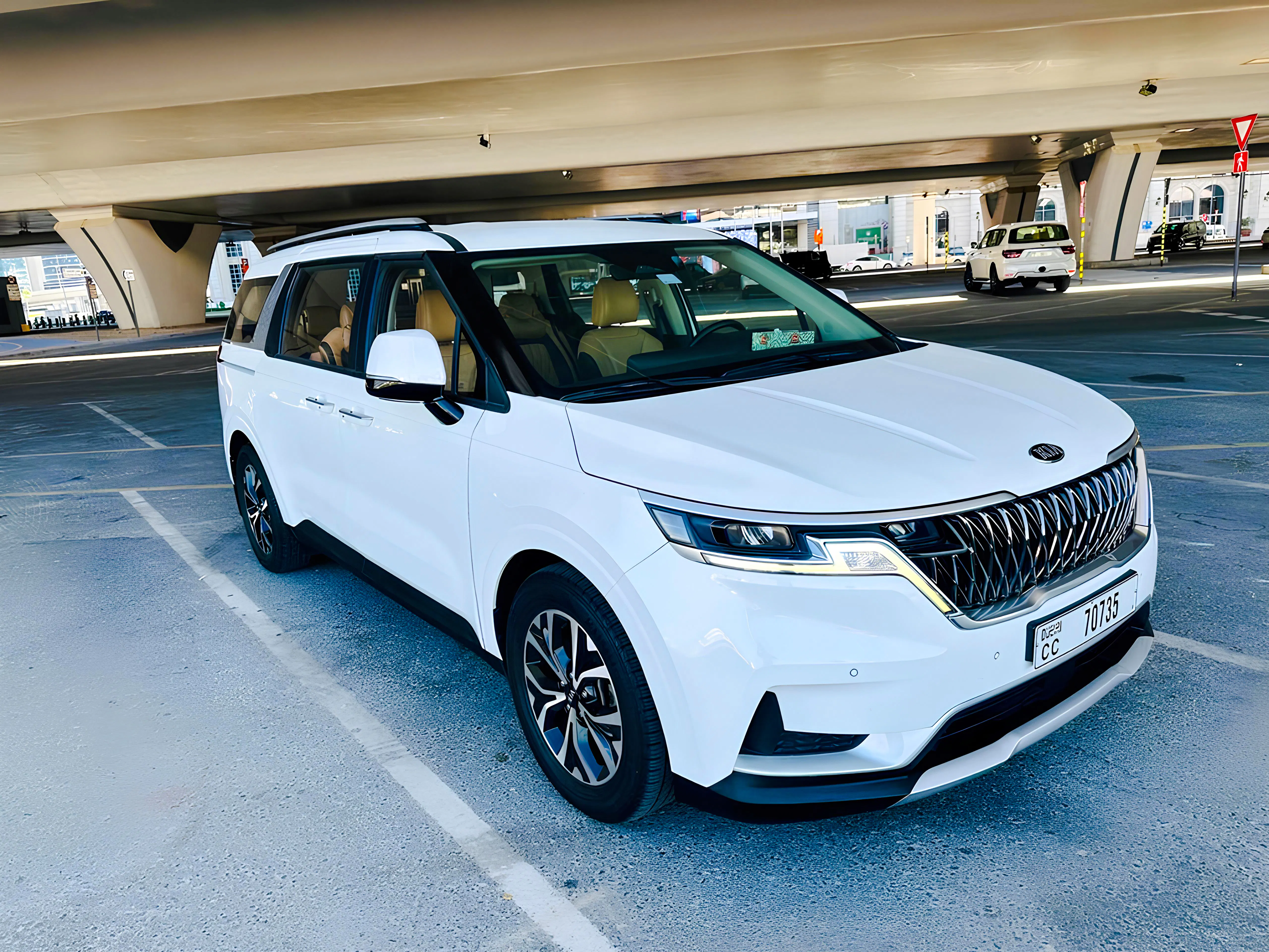 White minivan parked under a bridge in Dubai for a full-day private car tour.