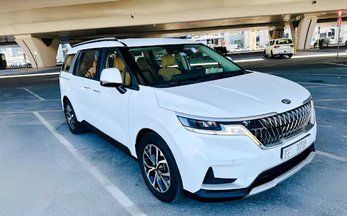 White minivan parked under a bridge in Dubai for a full-day private car tour.