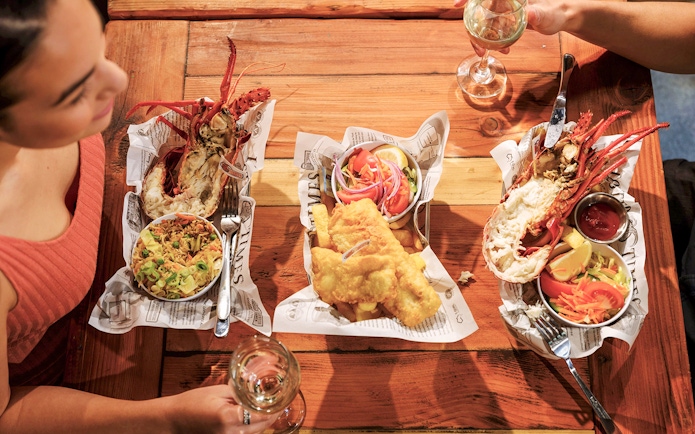 Lobster and fish meal on a wooden table during 1-Day Guided Pinnacles Lobster Lavender Tour from Perth.