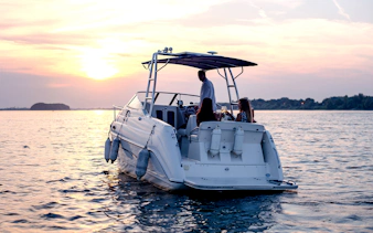 Speedboat tour of southern islands at sunset with people enjoying drinks.