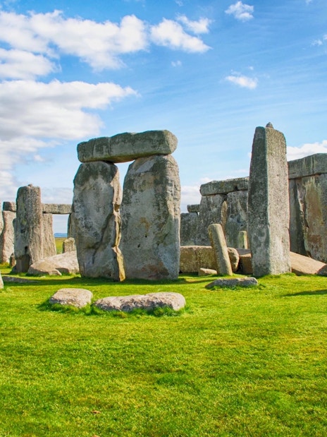 Stonehenge stone circle under a blue sky in Wiltshire, England.