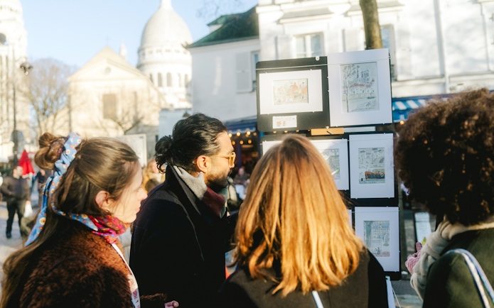People viewing art on Montmartre Walking Tour in Paris.