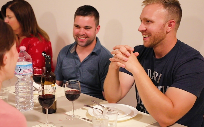 Participants enjoying a meal during a cooking class in Florence.