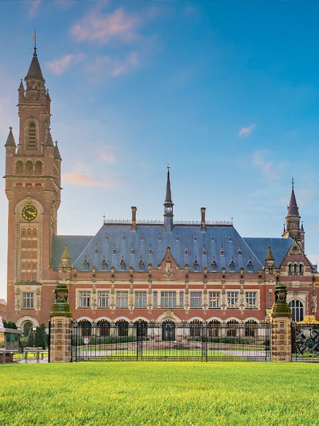 Peace Palace in Hague, home to the International Court of Justice, with clock tower and gardens.