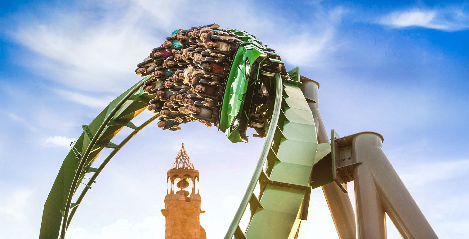 Guests on a rollercoaster with Islands of Adventure tower in background, Universal Studios Orlando.
