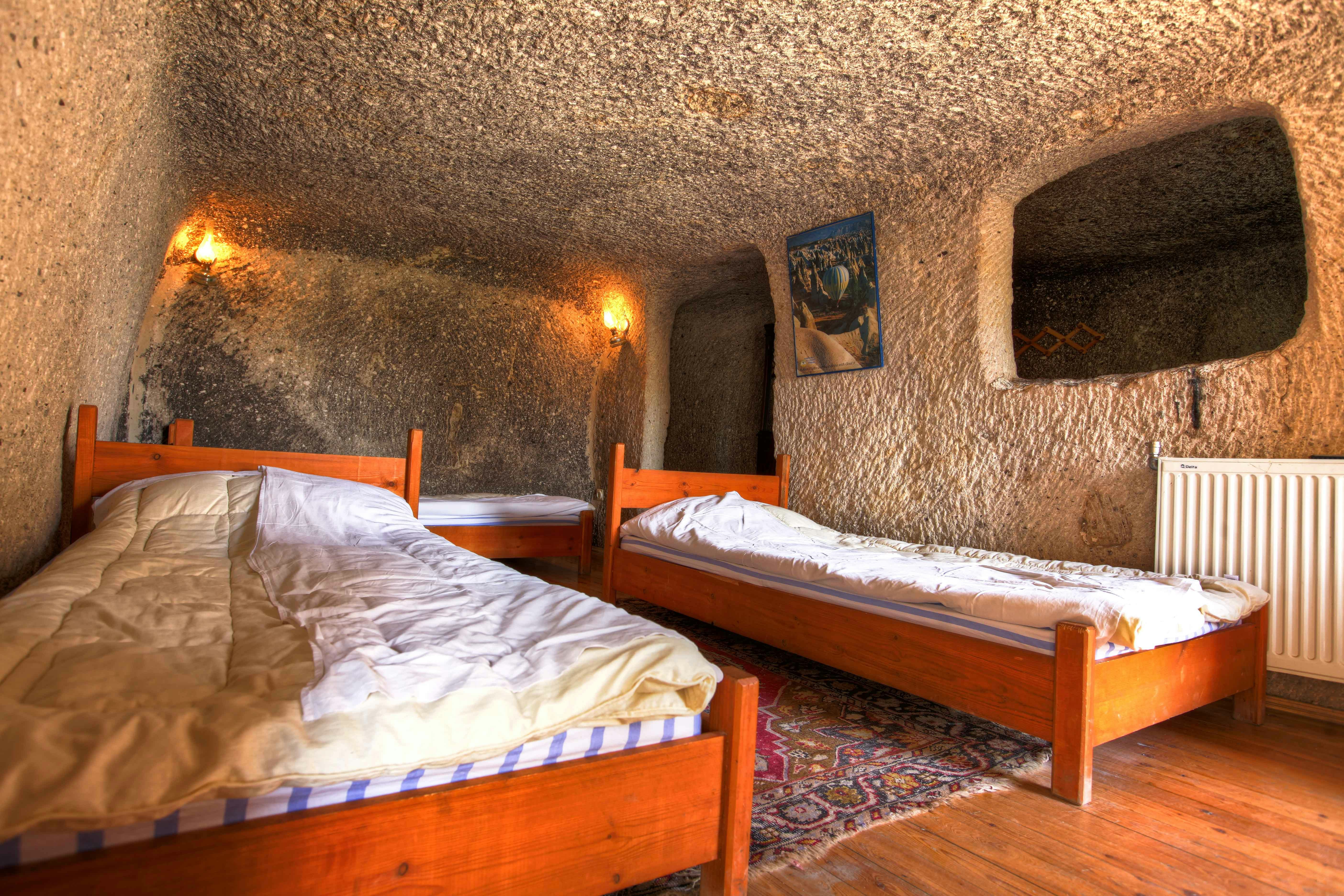 Two beds in a cave room at Kayakapi Premium Caves, Cappadocia.