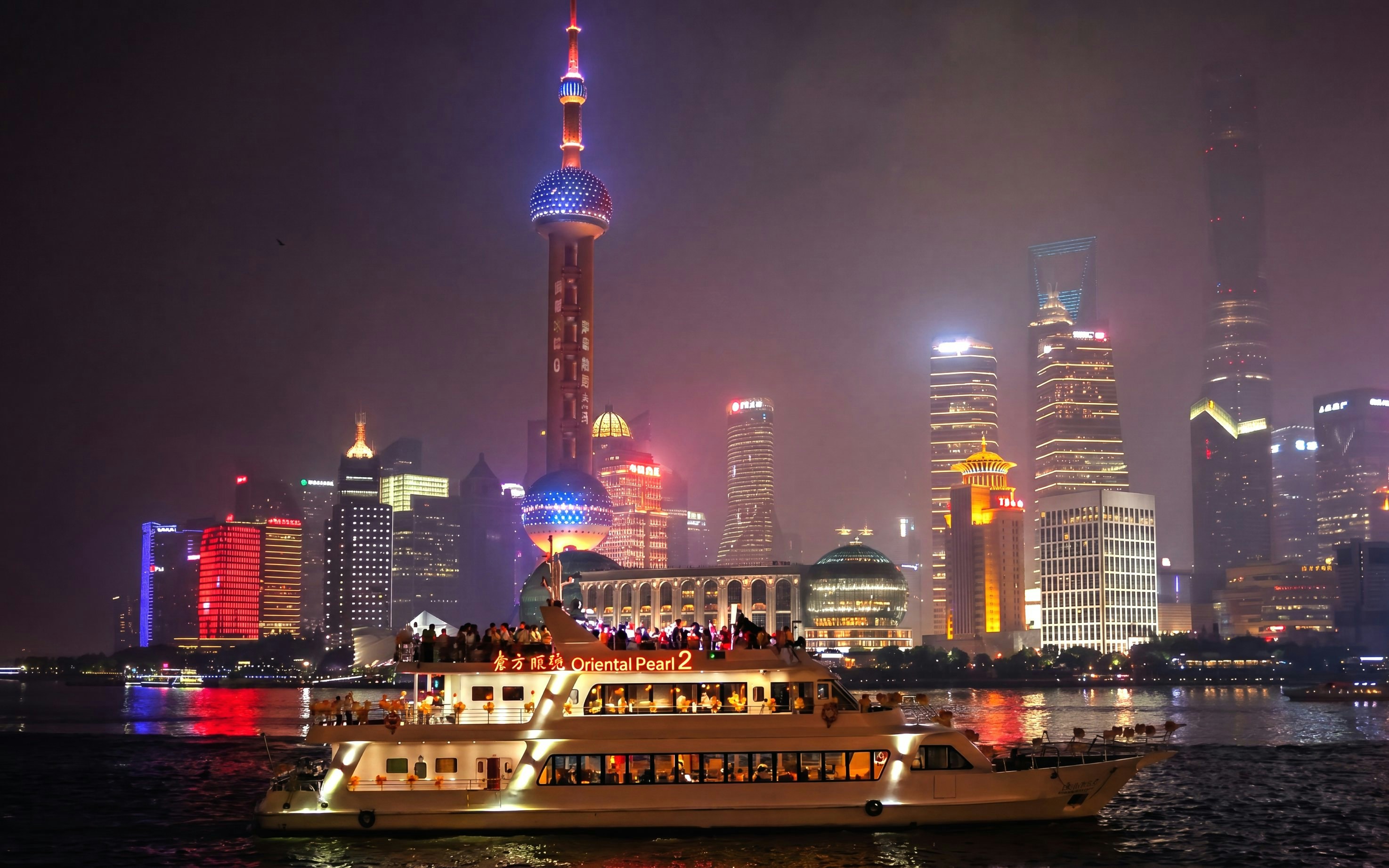 Cruise on Huangpu River with Shanghai skyline, including Oriental Pearl Tower.