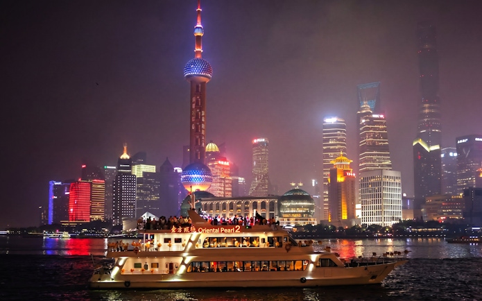 Cruise on Huangpu River with Shanghai skyline, including Oriental Pearl Tower.