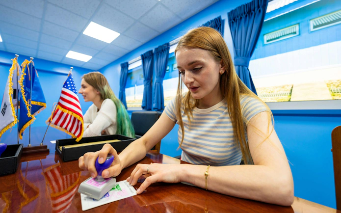 Participants stamping documents at JSA Museum during Half-Day DMZ Tour from Seoul.