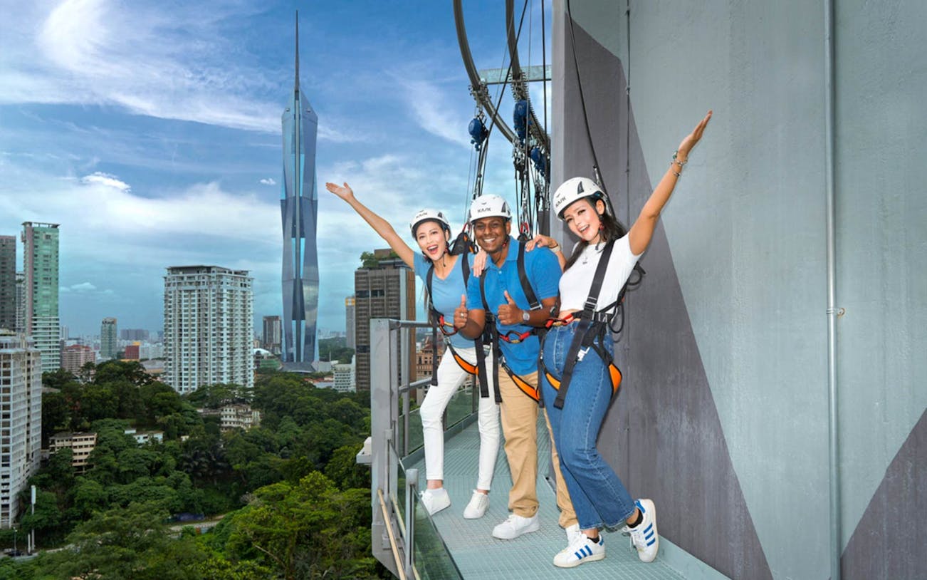 Visitors enjoying the Sky Deck at KL Tower with city skyline in the background.