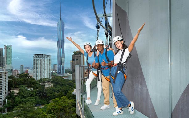Visitors enjoying the Sky Deck at KL Tower with city skyline in the background.