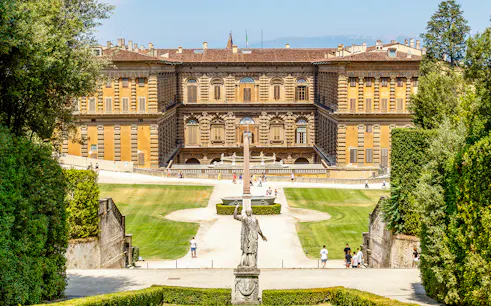 Gardens and exterior view of Pitti Palace in Florence, Italy, with visitors exploring.