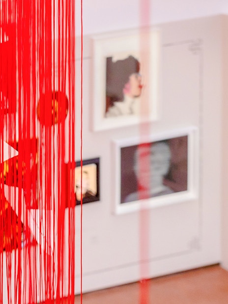 Exhibition view with red string installation and framed artworks at Heidi Horten Collection Vienna.