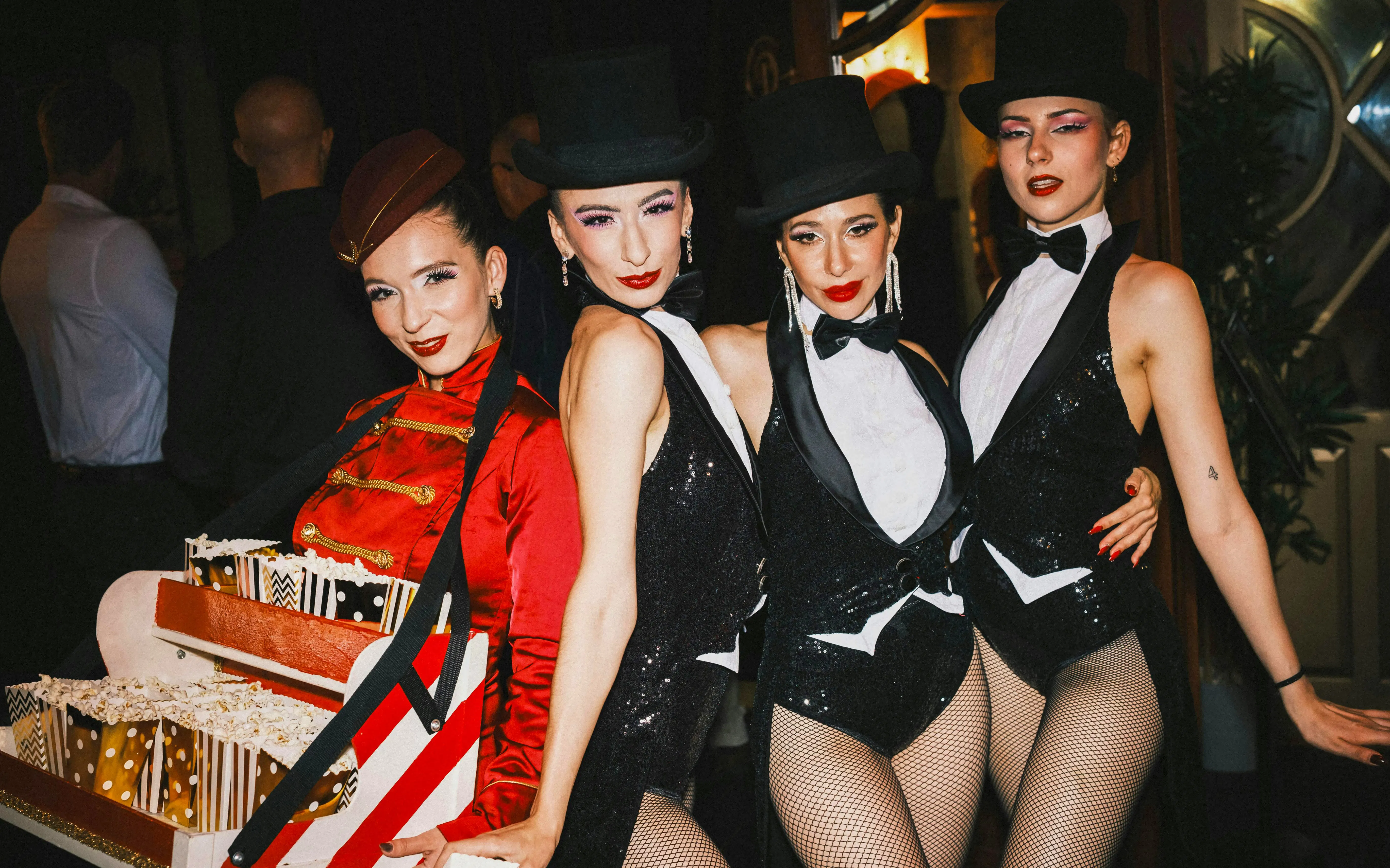 Performers in sequined outfits and top hats at a Burlesque Dinner Club in Vienna.