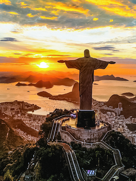 Aerial view of sunset over Christ the Redeemer statue in Rio de Janeiro, Brazil.