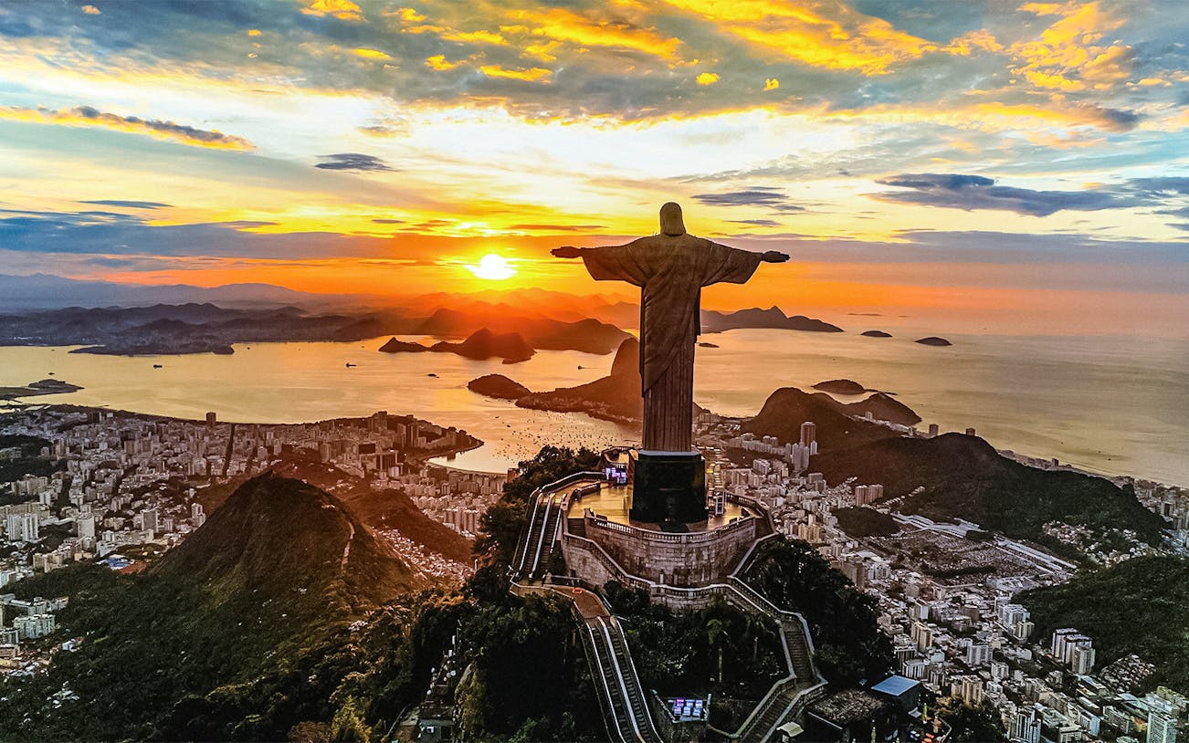 Aerial view of sunset over Christ the Redeemer statue in Rio de Janeiro, Brazil.