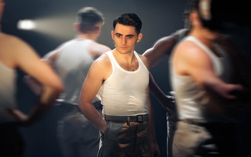 Performer in military attire on stage for "From Here To Eternity – The Musical.