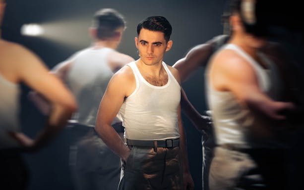 Performer in military attire on stage for "From Here To Eternity – The Musical.
