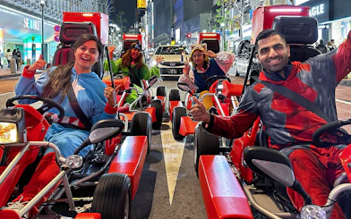 Participants in costumes on go-karts during a street tour in Shibuya, Tokyo.
