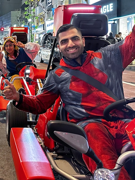 Participants in costumes on go-karts during a street tour in Shibuya, Tokyo.